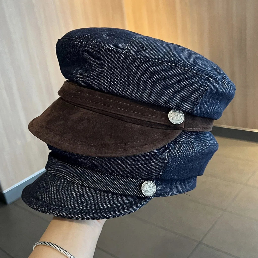 Adjustable octagonal denim newsboy hat in dark blue with contrast brim on white background