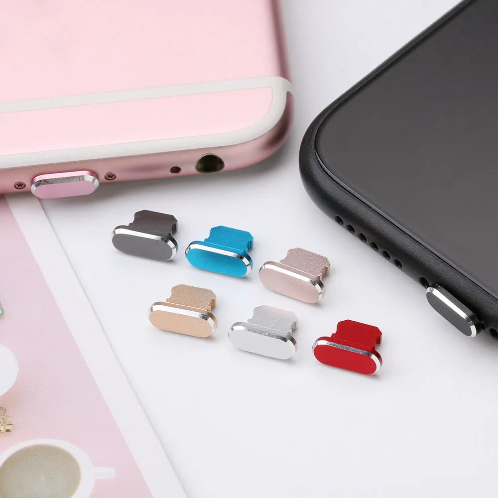 Aluminium alloy iPhone charging port dust plug in rose gold colour next to an iPhone.