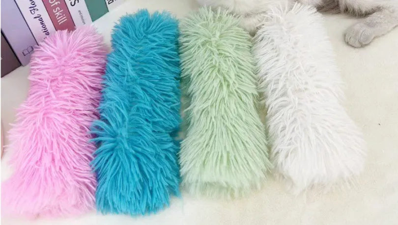 Plush cat toy pillow with squeaker in blue, green, pink, or white colours measuring 27cm by 10cm