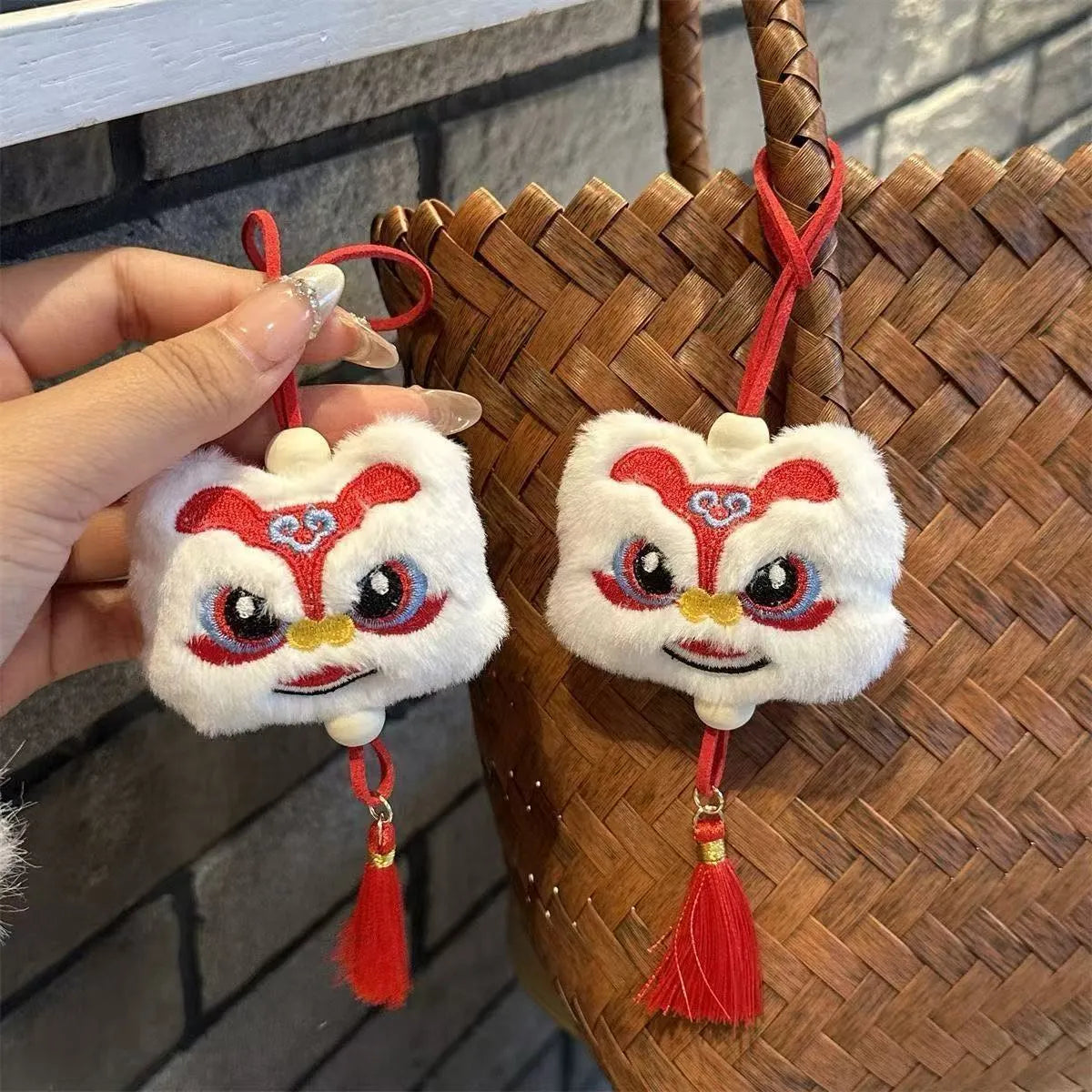 Blue and yellow Chinese style cartoon plush lion keychain ornaments with tassels and a star stone.