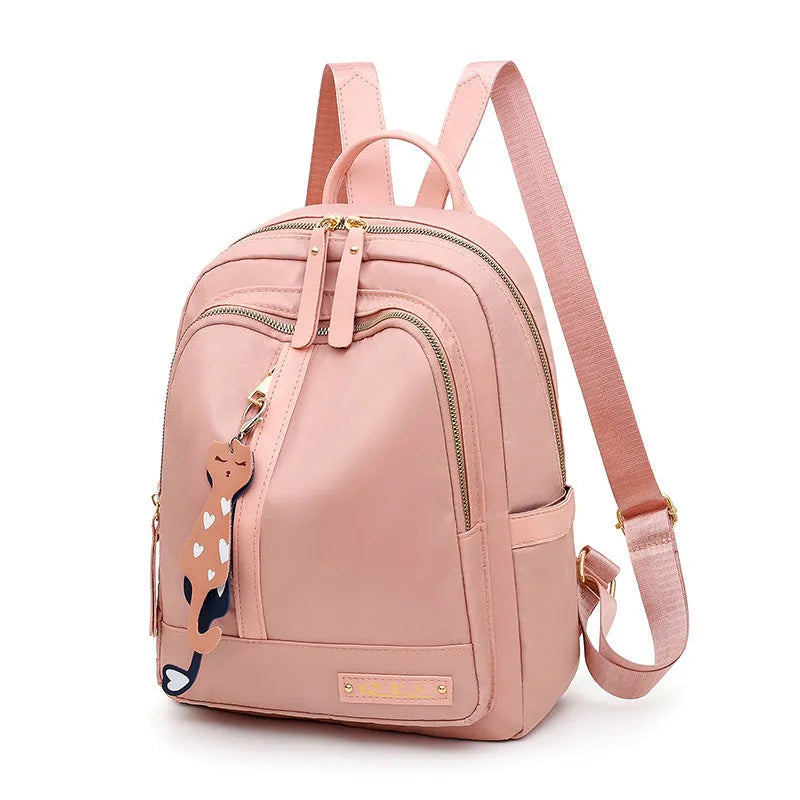 Black women's casual nylon backpack with soft handle and shoulder straps showing internal compartments