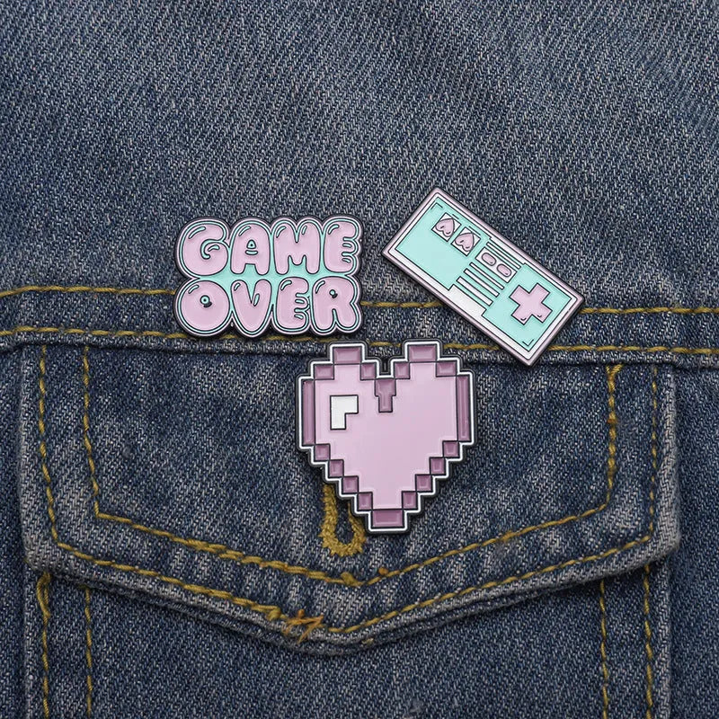 Stereo game console alloy pin badge in three colour options CC1122 CC1123 CC1124 on white background