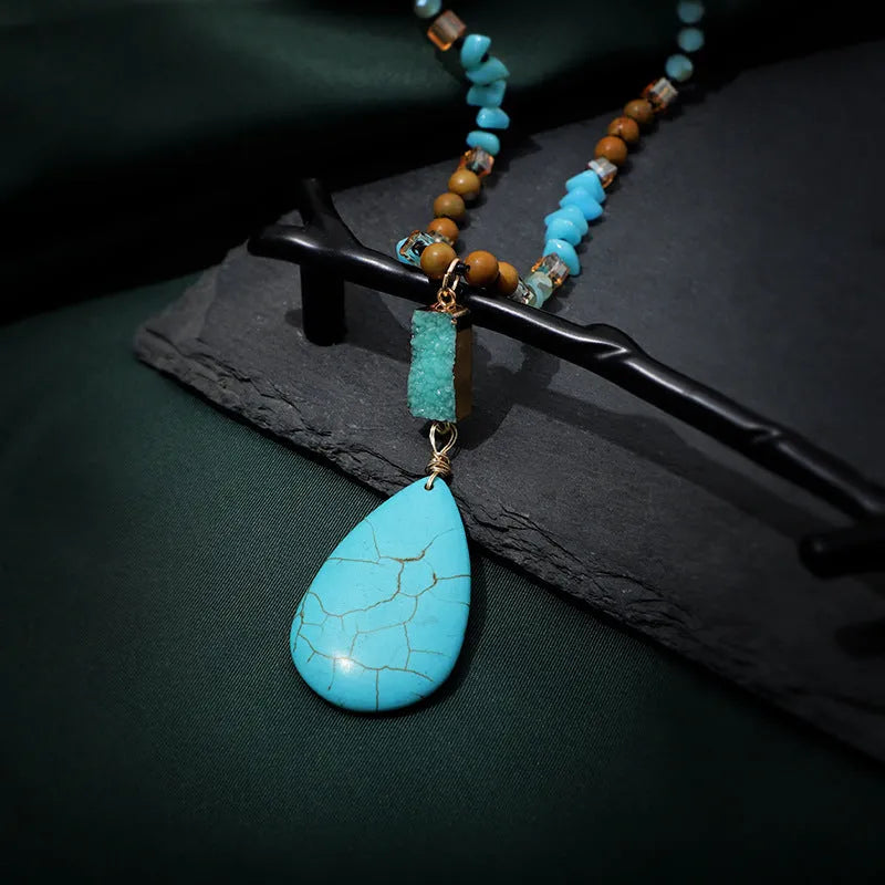 Long blue turquoise imitation mineral pendant necklace with a geometric setting on a ball bead chain.
