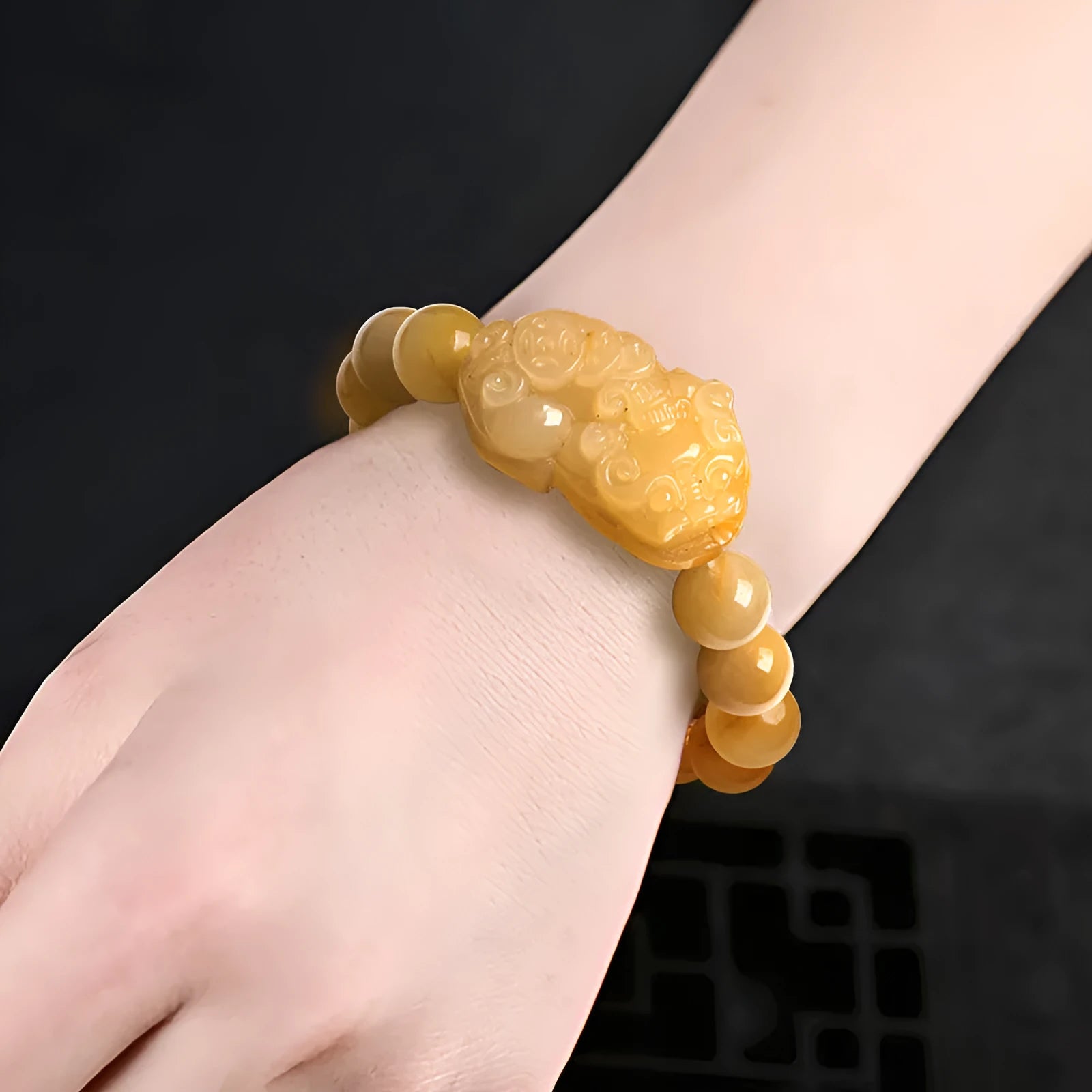 Golden thread Jinsi jade money bracelet with carved beads, shown in large and small size options.