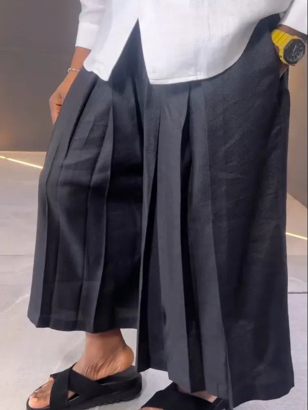 White asymmetric long sleeve shirt and black pleated pants set on model, regular fit, casual daily wear