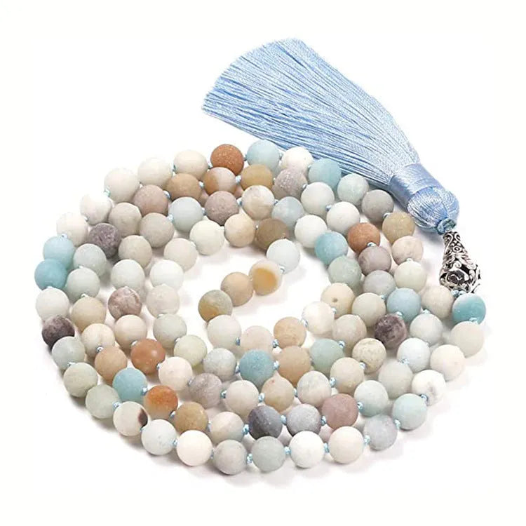 Long beaded agate and amethyst tassel necklace with blue grain stone and lapis lazuli on a geometric design.