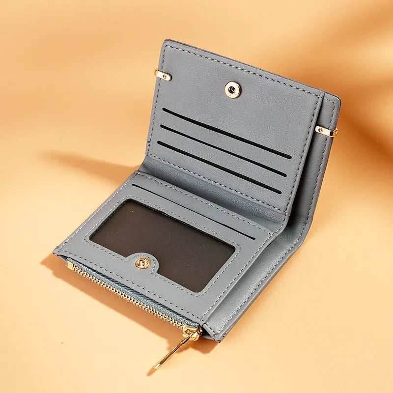 Black PU leather ladies wallet open to show multiple card slots, a bill compartment, and a zippered section.