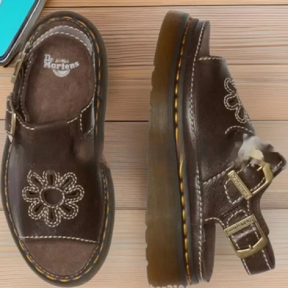 Men's black embroidered floral beach sandals with flat heel on a plain background.