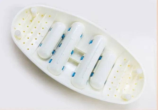White dual foot acupressure massager roller for plantar fasciitis relief, with textured plastic surface