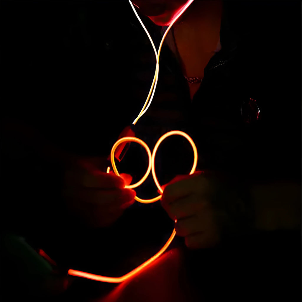 Blue Magic Light LED earphones with aluminium alloy shells and glowing cable connected to a phone.