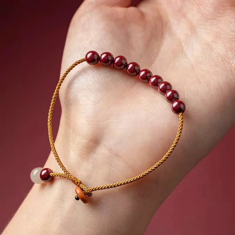 Hand-woven natural cinnabar bracelet with simple geometry shape on light background