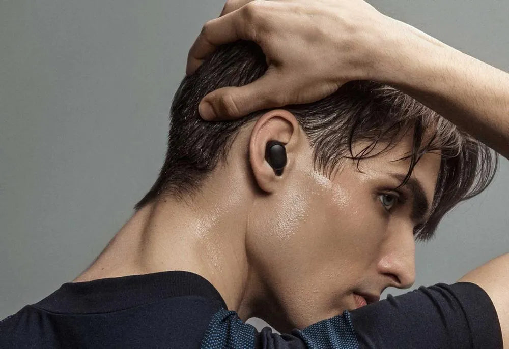 Black Redmi AirDots 2 true wireless earbuds with their compact charging case.