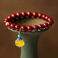 Handmade cinnabar bracelet with copper bead accent in wave shape, unisex design, available in pumpkin or brand cinnabar