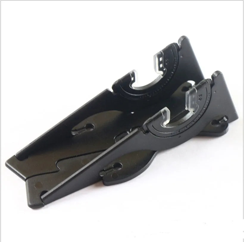Black plastic card type mobile phone holder on desktop with smartphone
