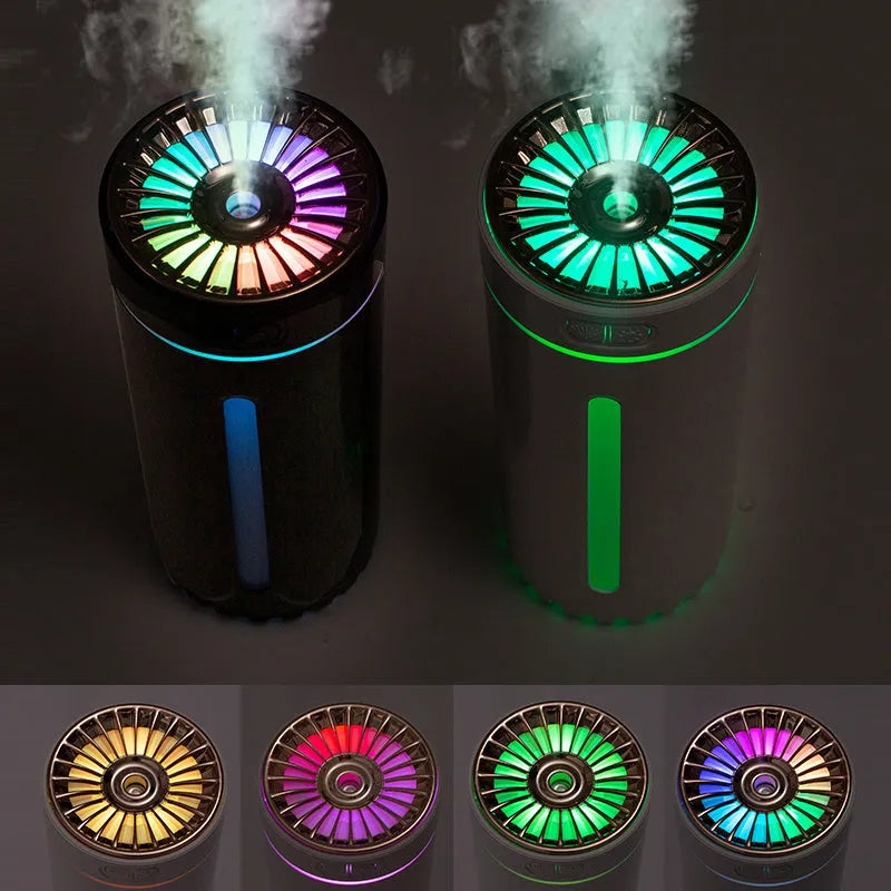 Black wireless ultrasonic humidifier with LED lights sitting in a car cup holder.