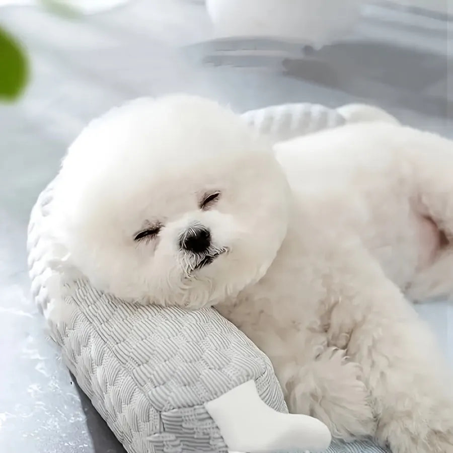 Blue big-eyed monster design breathable pet cooling bed for dogs and cats on a wooden floor.