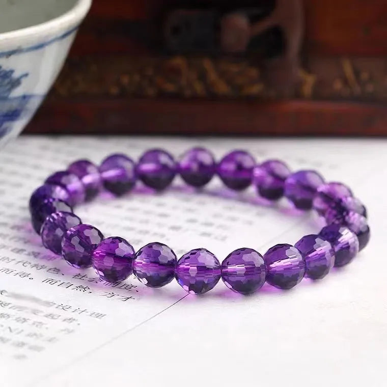 Handcrafted unisex crystal bracelet with 128-facet beads in amethyst, available in multiple bead diameters.