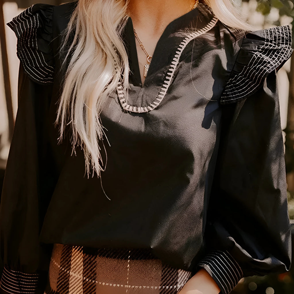 Black women's V-neck blouse with long ruffle sleeves and contrast stitching