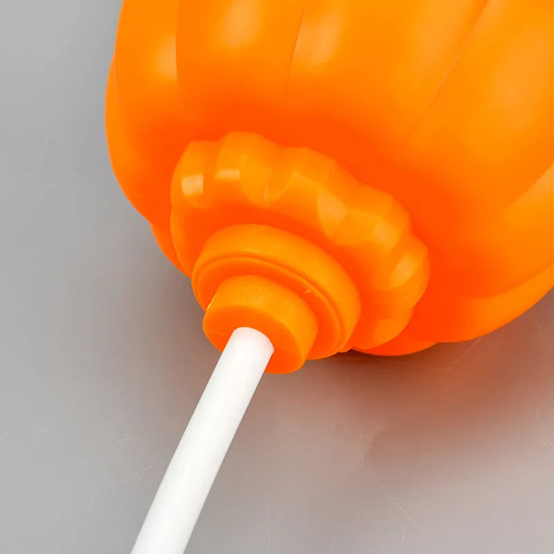 Plastic pumpkin-shaped decorative lamp with USB charging port, showing yellow or purple light option.