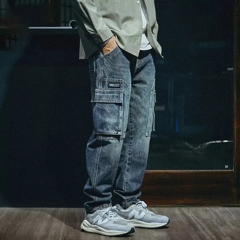 Man wearing blue loose straight-leg retro style stretch denim casual trousers