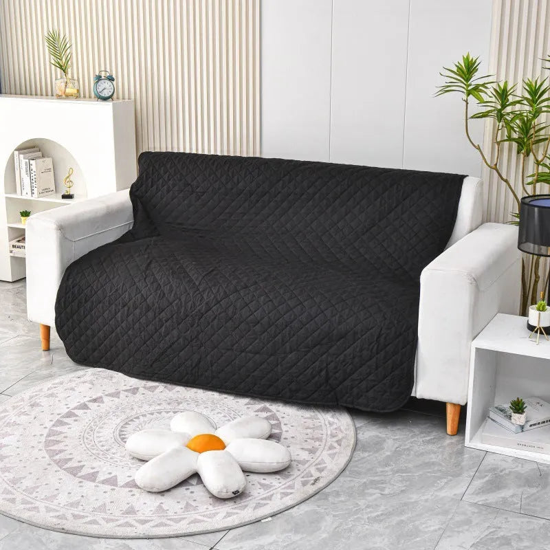 Reversible dog blanket couch cover in black with double-layer design, laid flat on sofa