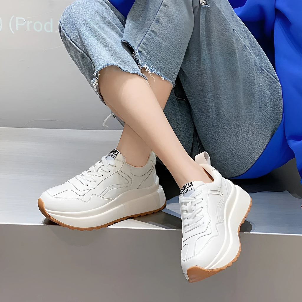 Beige women's low-top leather casual shoes with cross strap and a distinctive English muffin heel.