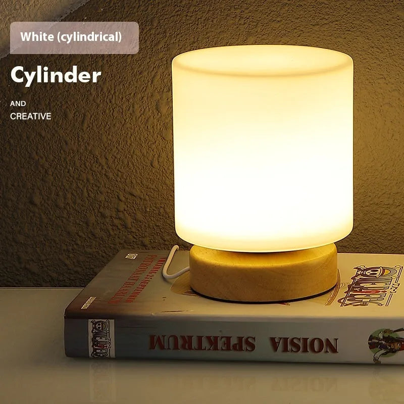 Nordic solid wood USB bedside lamp with flower-shaped design in white cylinder style on wooden surface
