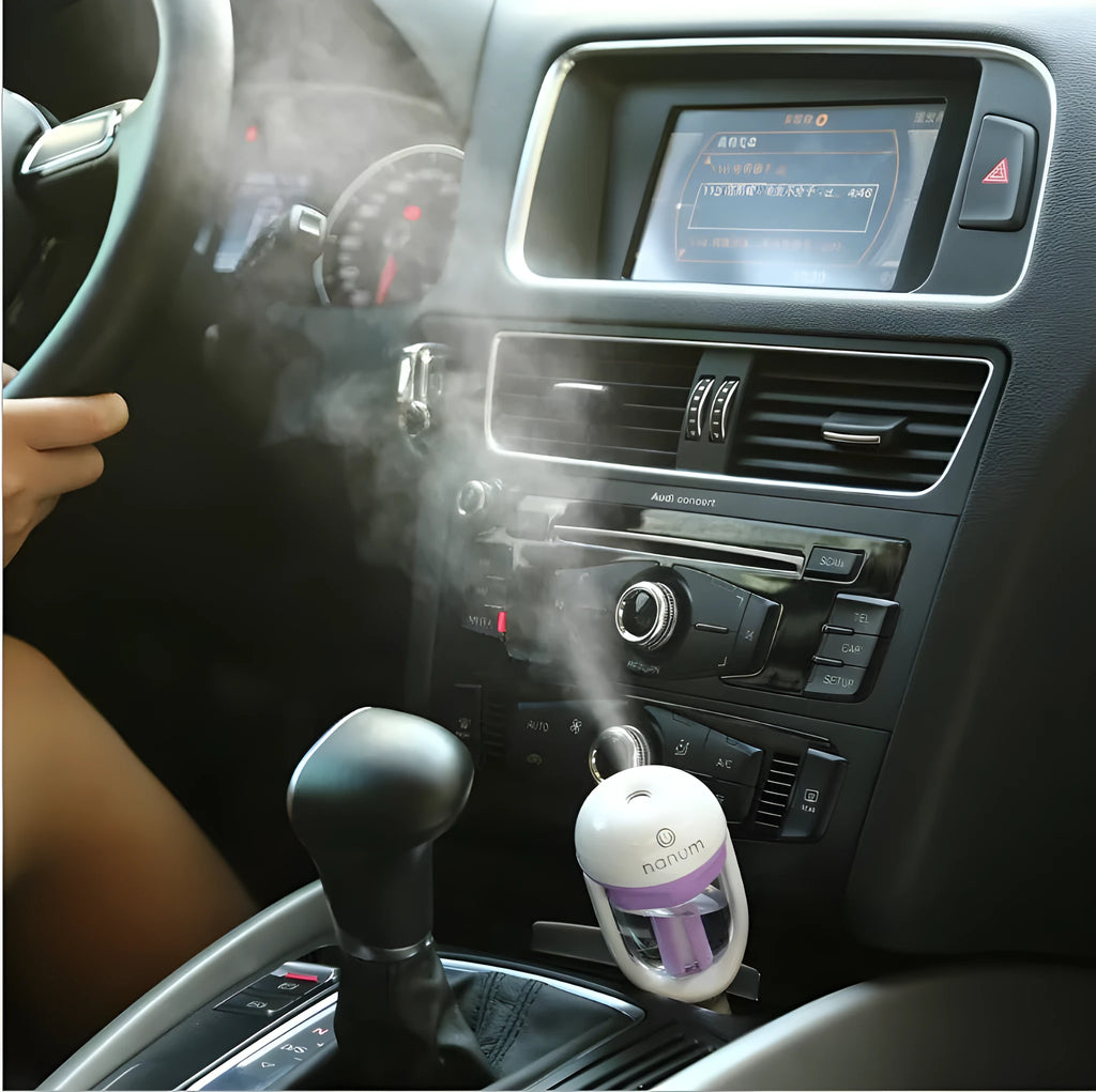 Portable mini car humidifier and essential oil diffuser with rotating nozzle in multiple colours.