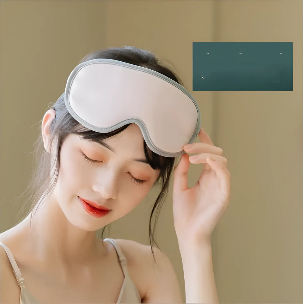 Green portable eye SPA massage goggles with USB cable on a white background.