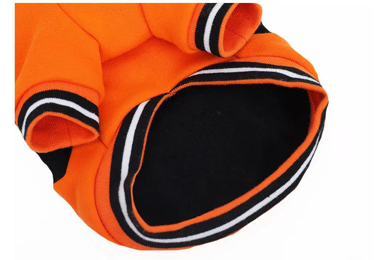 Orange cloth Halloween pumpkin costume for dogs shown on a pet with collar and back measurements from XS to XXL