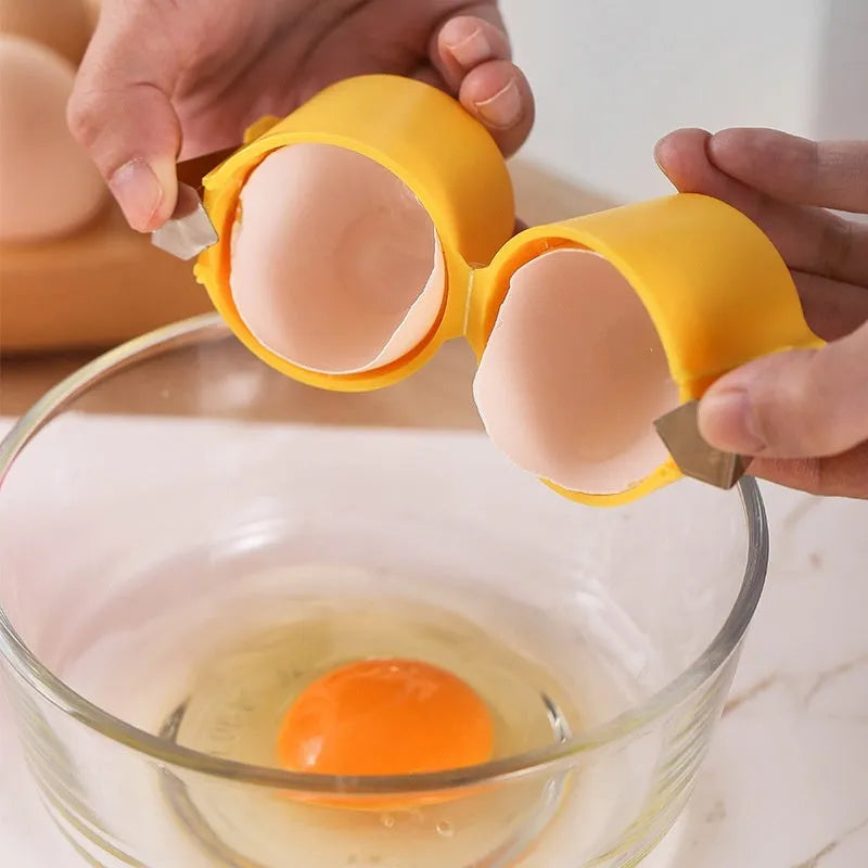 Egg shell opener and beater in pink with stainless steel mechanism on white background