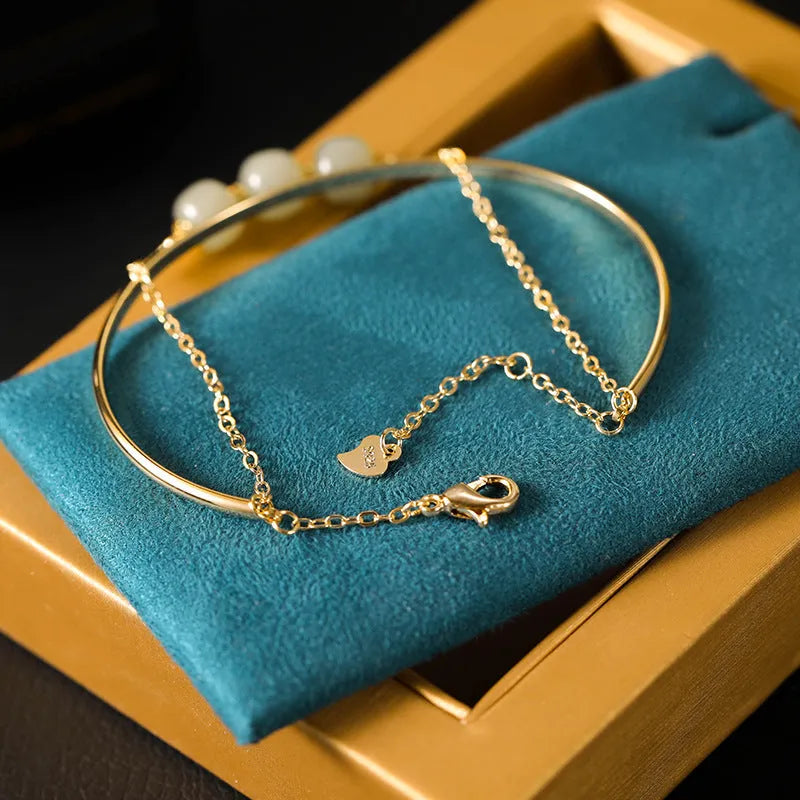 Hetian jade lucky beads bracelet with gold inlay, shown in women's fake two pieces style.