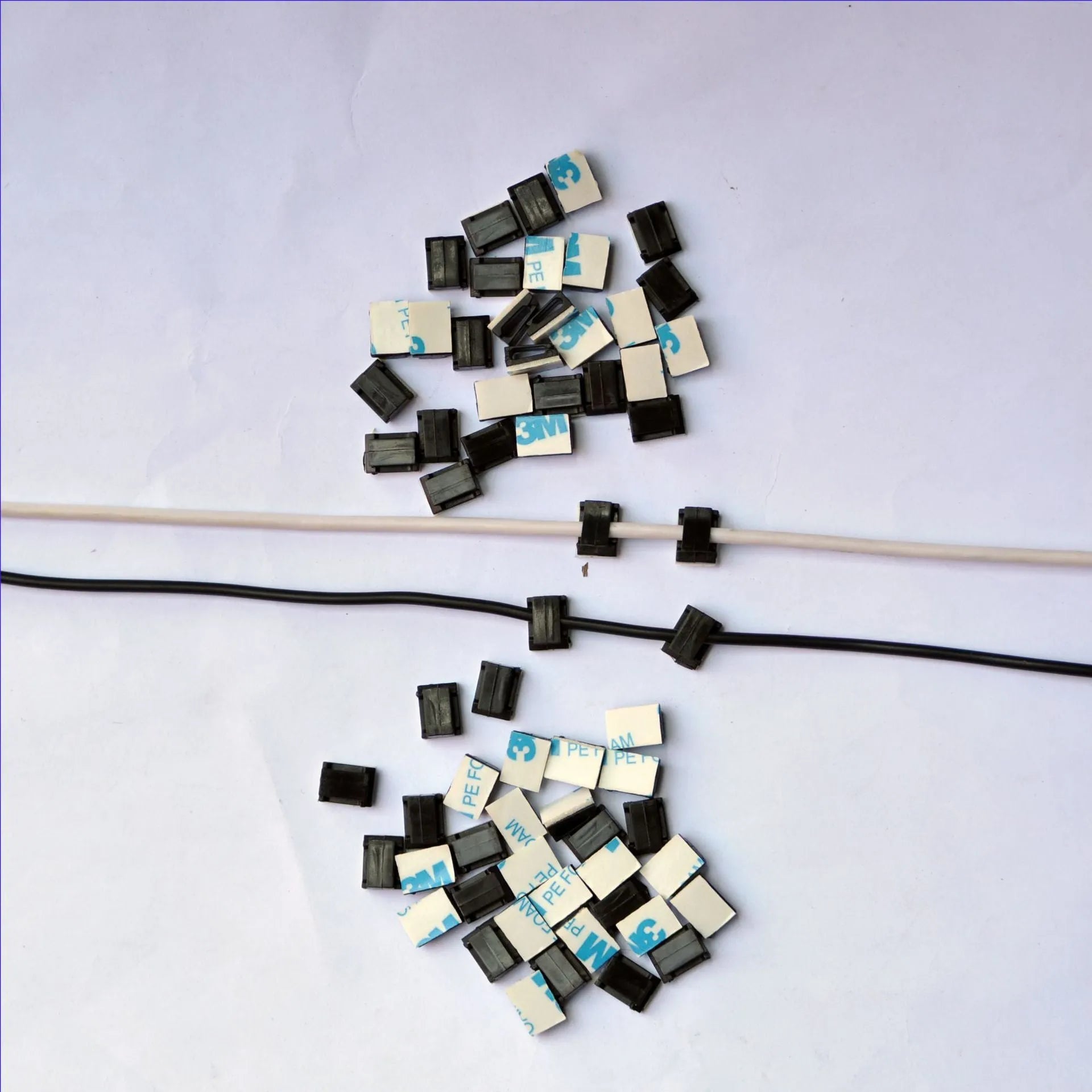 Black PA66 nylon wire management clips for automotive and electronic cable organisation