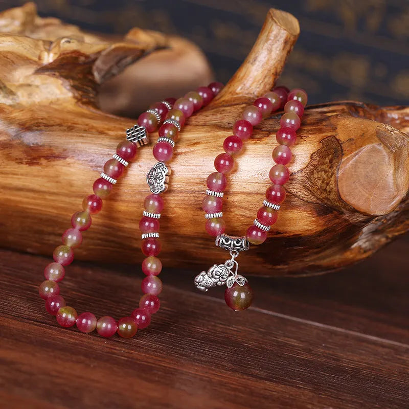 Natural watermelon crystal Chinese knot bracelet with elephant style beads.