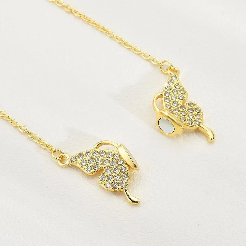 Gold titanium steel clavicle necklace with magnetic snap and butterfly pendant on twisted chain.