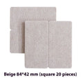 Beige plastic furniture leg protection pads in round and square shapes on wooden floor