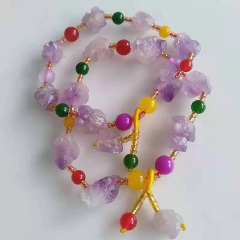 Natural shaped purple amethyst bead bracelet with a silver fu charm on an adjustable knotted cord.