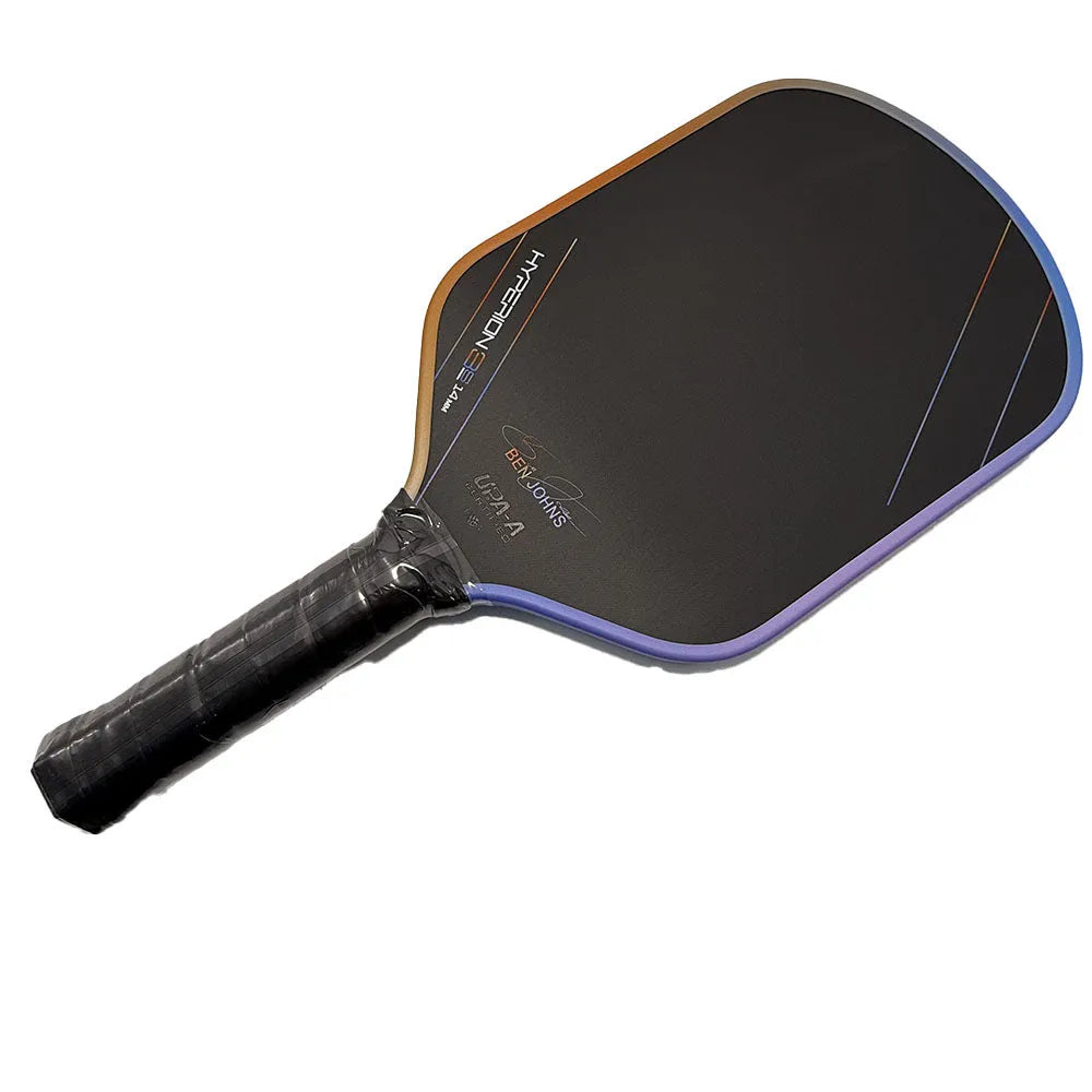 Multicolour matte-finish pickleball racket showing carbon fibre texture and honeycomb core construction.