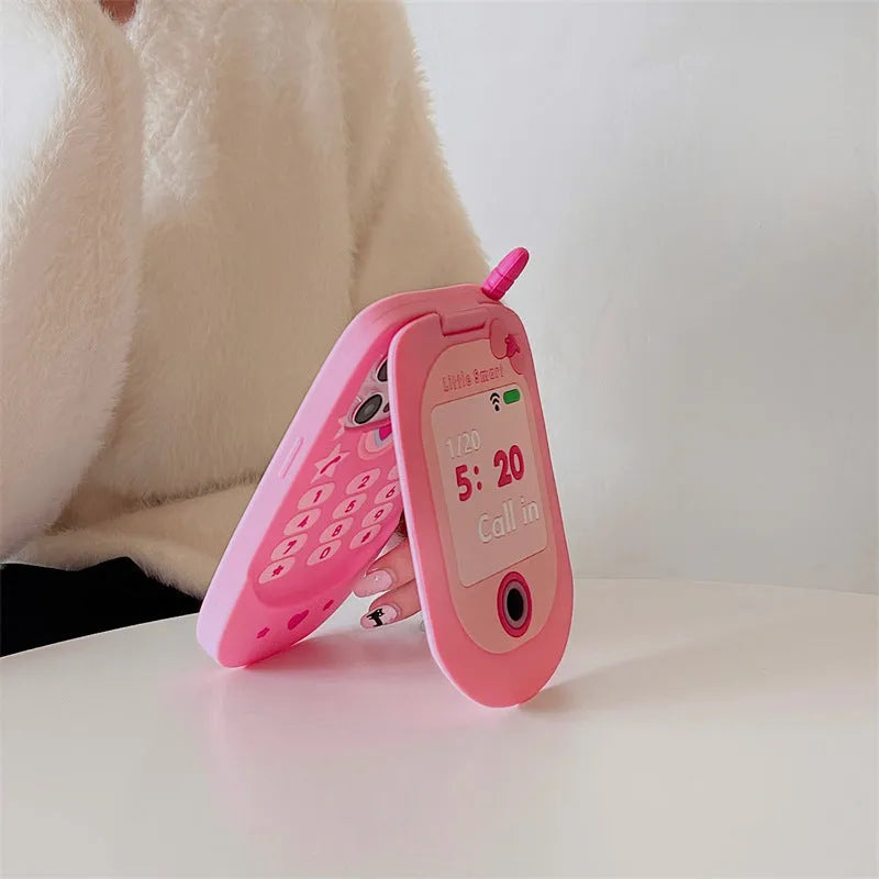 Light pink silicone flip phone shaped mirror case for iPhone on a white background.