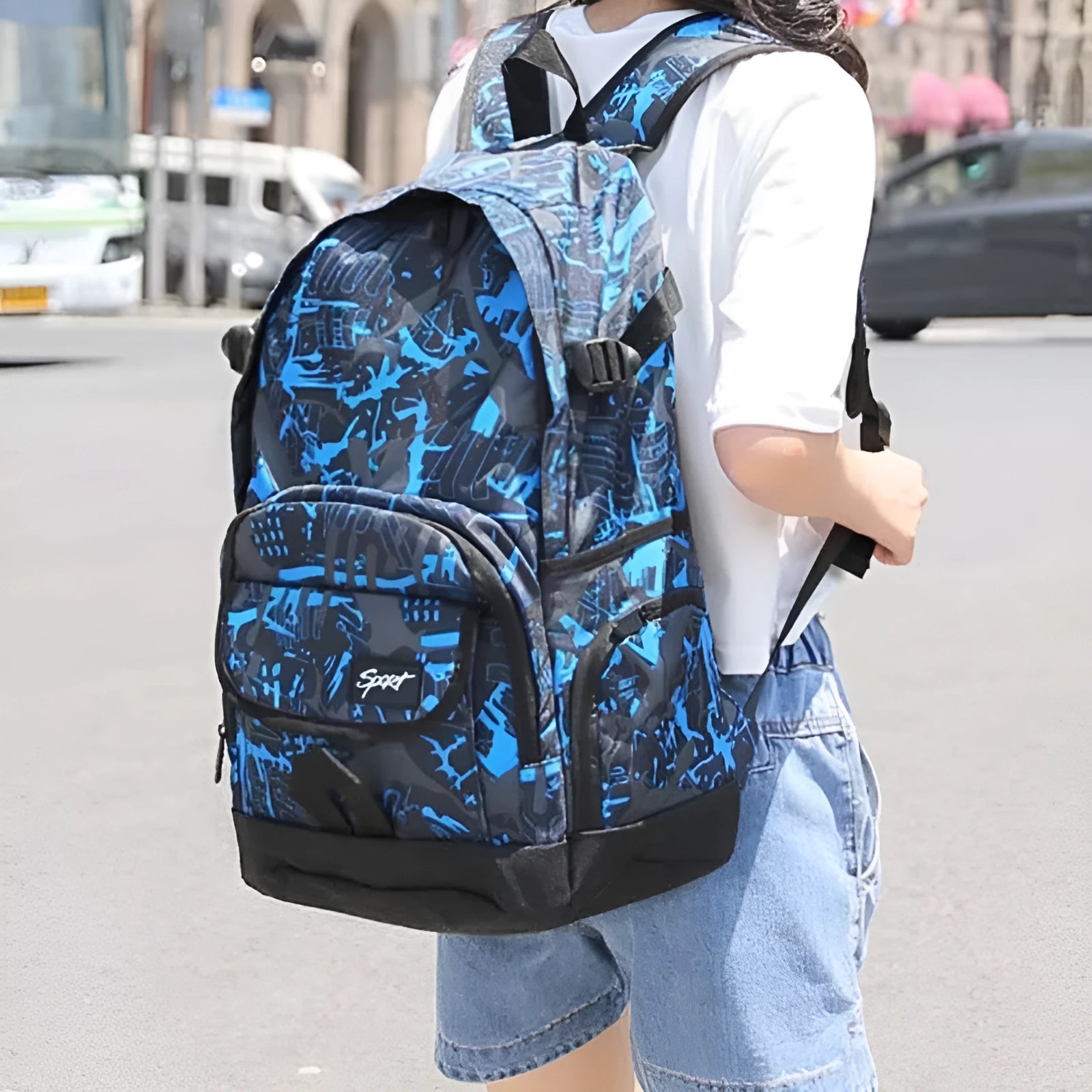 A blue classic nylon backpack with large capacity, showing padded straps and a front pocket.