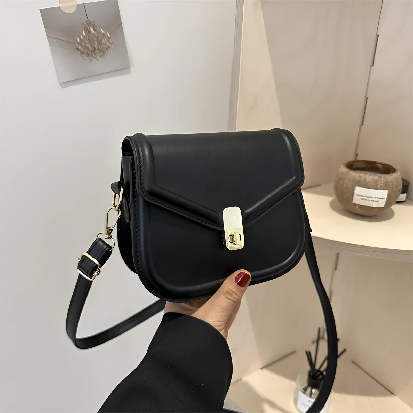 PU leather soft shell messenger bag with clamshell opening in a horizontal square shape.