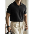 Men's short-sleeved blue polo shirt with a placket and collar, laid flat.