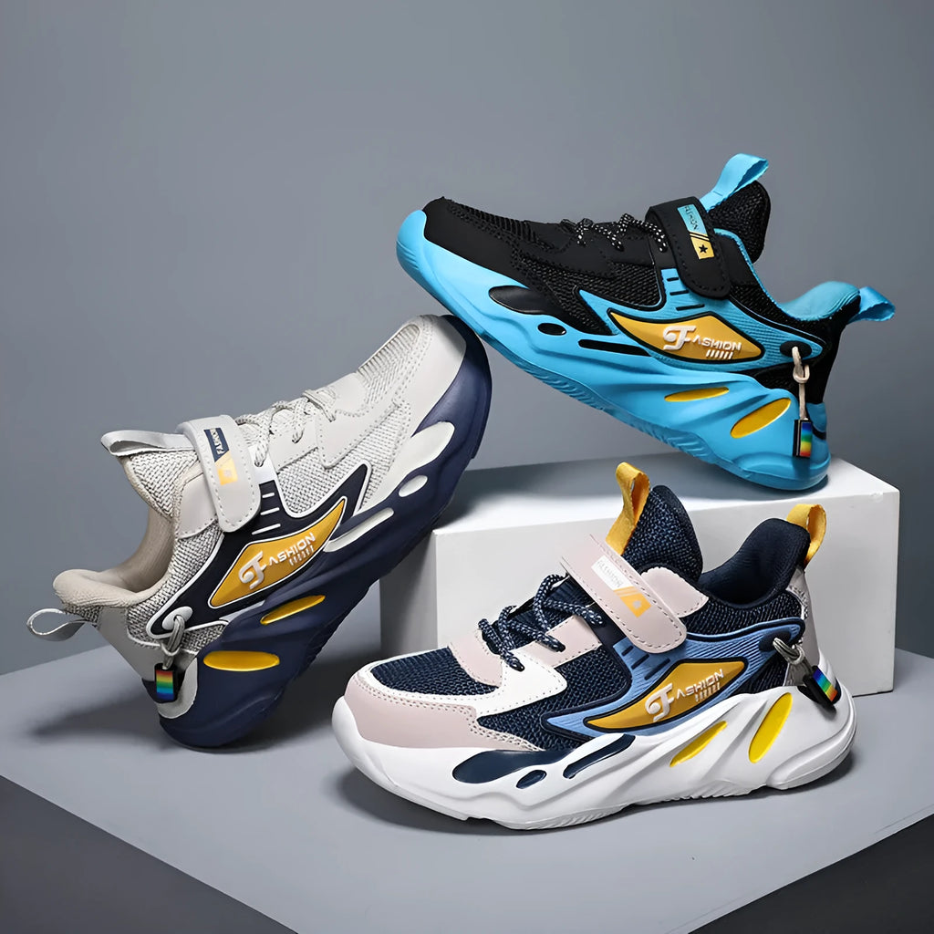 Boys' blue and black Velcro fastening sports running shoes on a white background.