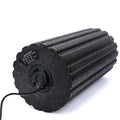 Black 4 speed vibrating massage roller foam on a floor for muscle recovery use