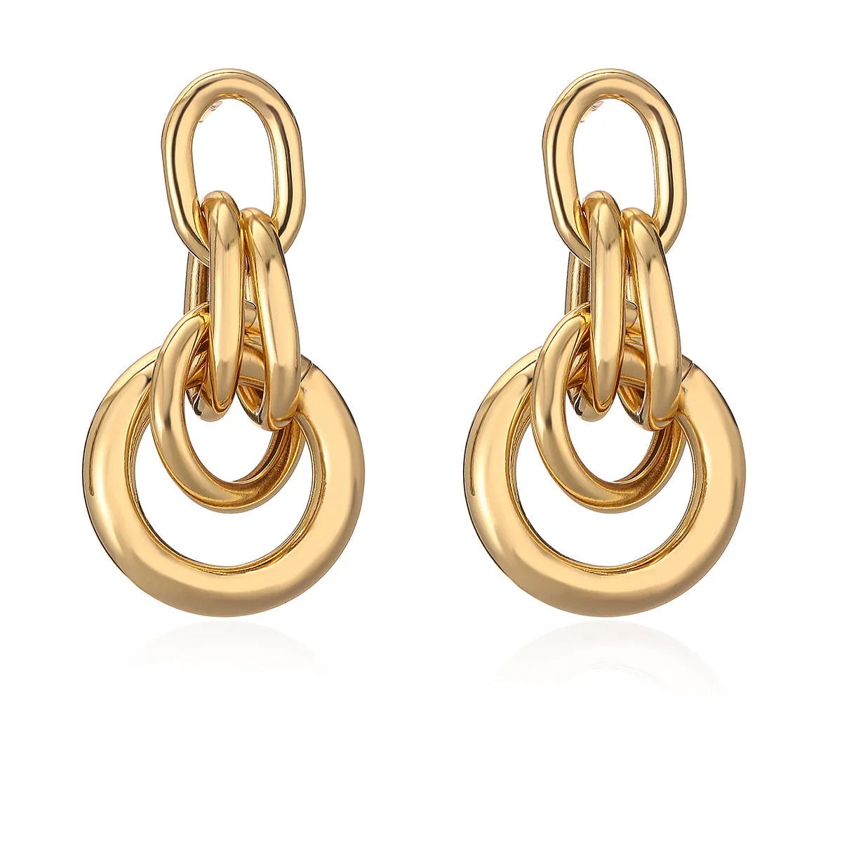 A pair of gold geometric drop earrings with an irregular asymmetric shape, made from copper.