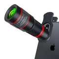20x magnification smartphone telescope with universal mounting clip and plastic housing on a wooden table.
