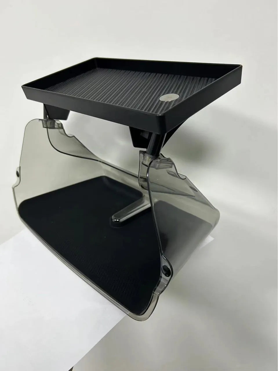 White ABS plastic storage box fitted under the screen of a Tesla Model 3 for small items