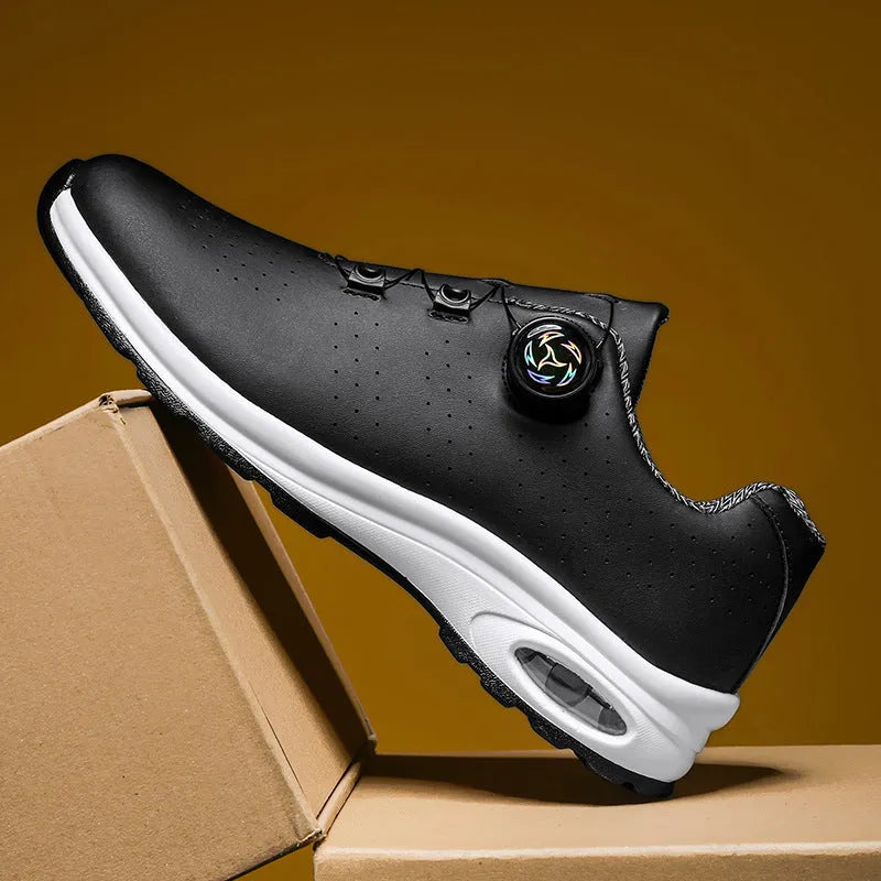 Black and white low top mesh tennis shoes with a round toe and flat composite sole on a plain background.