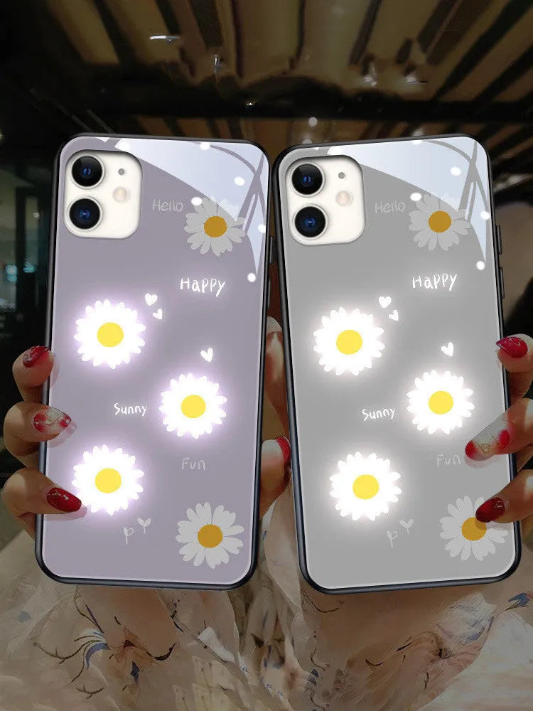 White Apple iPhone case with painted daisy pattern and illuminated voice-activated colour light on display.