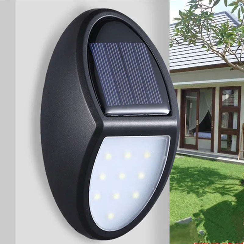 Black solar-powered wall light with automatic sensor for garden and outdoor security lighting